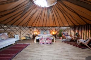 a large room with a bed in a yurt at JOY Retreat in Isle of Jersey