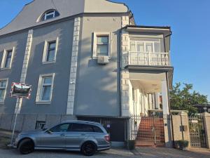 a silver car parked in front of a house at Vila mijajlovic in Svilajnac