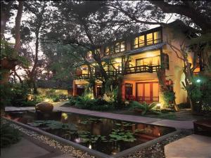 a house with a pond in front of it at Baan Talay Dao Resort in Hua Hin