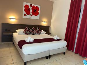 a bedroom with a large bed with red curtains at Stella Marina in Macinaggio +18 photos