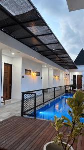 a swimming pool in the middle of a house at Elbara Guest House Syariah in Banjarbaru