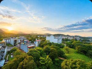 a city with buildings and trees and the sunset at Bravon Sky Hotel in Kurunegala