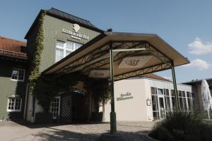 a building with awning in front of a building at Hotel Bayerischer Hof Miesbach, BW Premier Collection in Miesbach