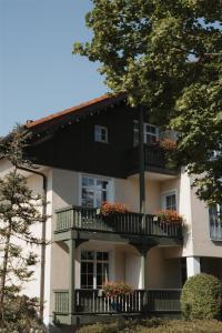 a building with a balcony with flowers on it at Hotel Bayerischer Hof Miesbach, BW Premier Collection in Miesbach +131 photos