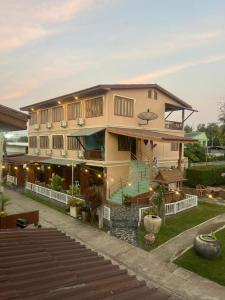a large building with a balcony on the side of it at Srisawat Resort in Cha Am