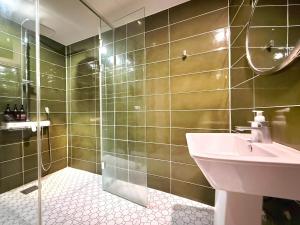 a bathroom with a sink and a shower at Hotel Yaja Gwangalli in Busan
