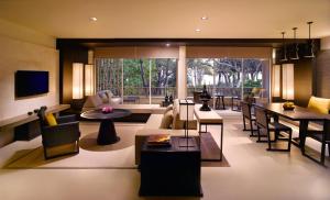 a living room with a couch and a table at Hyatt Regency Hua Hin in Hua Hin