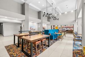 a dining room with tables and blue chairs at Hampton Inn and Suites Peru in Peru