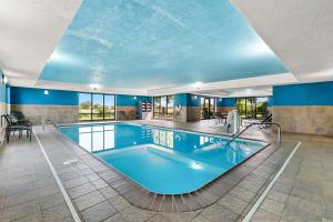 a large swimming pool in a building with blue walls at Hampton Inn and Suites Peru in Peru