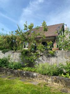 a house behind a retaining wall at Charming House In Herrliberg in Herrliberg
