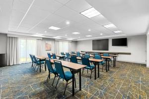 a conference room with tables and chairs and a screen at Hampton Inn and Suites Peru in Peru +25 photos