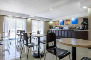 a restaurant with tables and chairs and a counter at Comfort Inn in North Bay