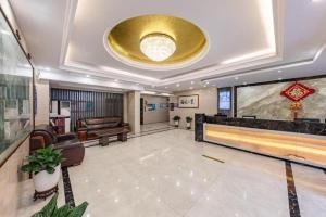 a large lobby with a bowling alley and a gold ceiling at Zhenxing Hotel in Shenzhen