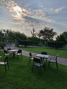 a group of tables and chairs sitting on the grass at Agriturismo Le Panizze in Centenaro