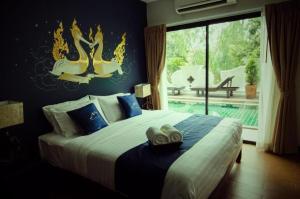 a bedroom with a large bed and a large window at Maytara Hotel in Pattaya South +87 photos