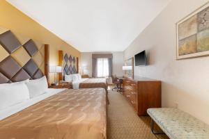 a hotel room with two beds and a television at Quality Inn Florida City - Gateway to the Keys in Florida City +92 photos