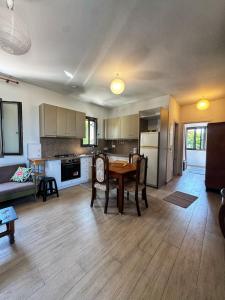 a living room with a table and a kitchen at Maria's Seafront Villa in Loutra Edipsou