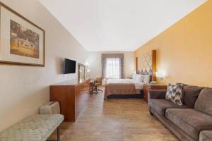 a hotel room with a couch and a bed at Quality Inn Florida City - Gateway to the Keys in Florida City