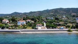 arial view of a city with a road and water at Maria's Seafront Villa in Loutra Edipsou