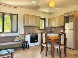 a kitchen with a table and a couch in a room at Maria's Seafront Villa in Loutra Edipsou