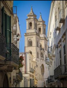 a tall building with a clock tower on a street at B&B Campisi Anna in Altamura