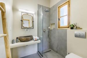 a bathroom with a sink and a shower at Amaranthos Garden Retreat in Skopelos Town