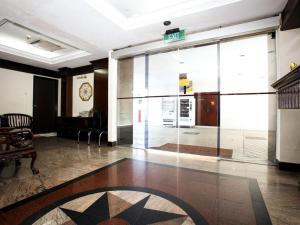 a lobby with a large glass door in a building at Darlene Hotel in Singapore