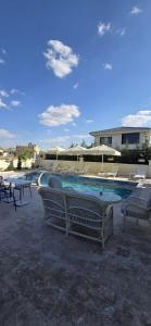a swimming pool with chairs and a table at İncebey Konak Cappadocia Swimming Pool in Uçhisar