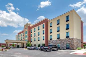 a large building with cars parked in a parking lot at Comfort Suites Midland West in Midland