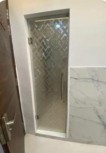 a shower with a glass door in a bathroom at Hotel elora 