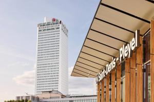 a tall white building in front of a building at H4 Wyndham Paris Pleyel in Saint-Denis