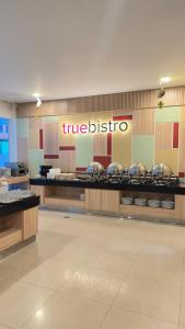a restaurant with a buffet line with silver pans at Alltrue Lite Hotel Nagoya Hill Batam in Nagoya
