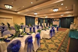 a banquet hall with white tables and purple chairs at Radisson Resort at the Port in Cape Canaveral +53 photos