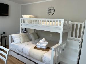 a white bunk bed with a teddy bear sitting on a rug at Zum Weinkrug - Apartments in Vienna