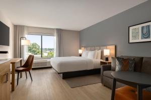 a large hotel room with a bed and a desk at Hyatt Studios Chesapeake in Chesapeake