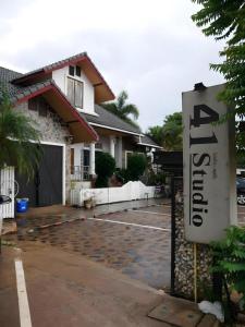a sign in front of a house with a garage at 41Studio in Nakhon Phanom