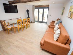 a living room with a couch and a table at Hay Barn in Carnforth