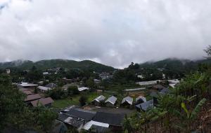a view of a village with houses and mountains at กลางขุนเขา klang khun khao in Ban Na Yang