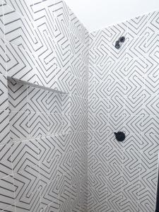 a bathroom with a white floor with a pattern at Loft Reforma in Oaxaca City