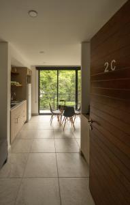 a kitchen with a table and chairs and a door at Loft Reforma in Oaxaca City