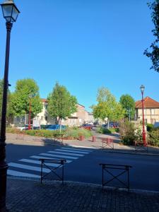 a street with two benches and a street light at Auberge leon xiv in Sarralbe