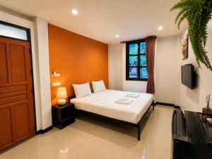 a hotel room with a bed and a window at SaintLove Hotel in Chiang Mai