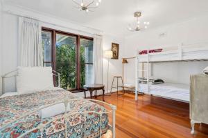 a bedroom with two beds and a window at Gunyha - Ocean Views, Walk to Beach, Free WiFi, Pet Friendly, Open Fire, Visiting Koalas and Other Wildlife. in Apollo Bay