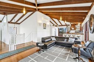 a living room with a couch and a table at Gunyha - Ocean Views, Walk to Beach, Free WiFi, Pet Friendly, Open Fire, Visiting Koalas and Other Wildlife. in Apollo Bay