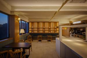 a kitchen and dining room with a table and chairs at Wolyoung Hotel By NewCZ in Andong