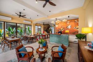 a restaurant with tables and chairs and a bar at Solea Boutique Hoi An - Grand Opening April 2026 in Hoi An