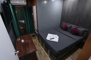 a small room with a bed in a boat at FabHotels Rovio in Visakhapatnam