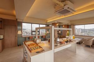 a kitchen with a counter with food on it at Wolyoung Hotel By NewCZ in Andong