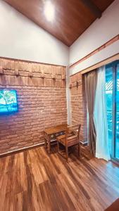 a room with a bench and a brick wall at Hide Away Resort in Jhārgrām