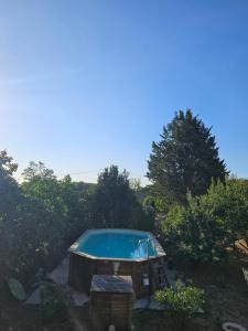 a swimming pool in a yard with trees at Chambre d'hôtes Le Luquet in Chazelles